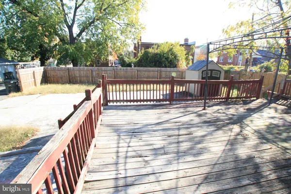 a balcony with wooden floor and fence