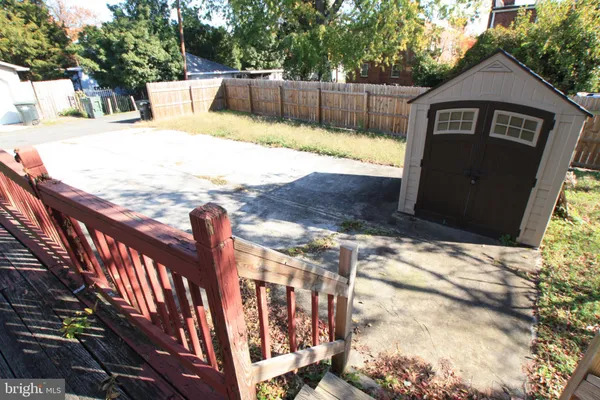 a view of a yard with wooden fence