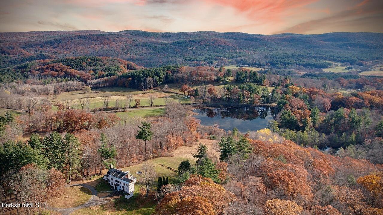 9 Brace Road Tyringham, MA 01264 - Photo 1 of 27 a view of a lake with mountains in the background