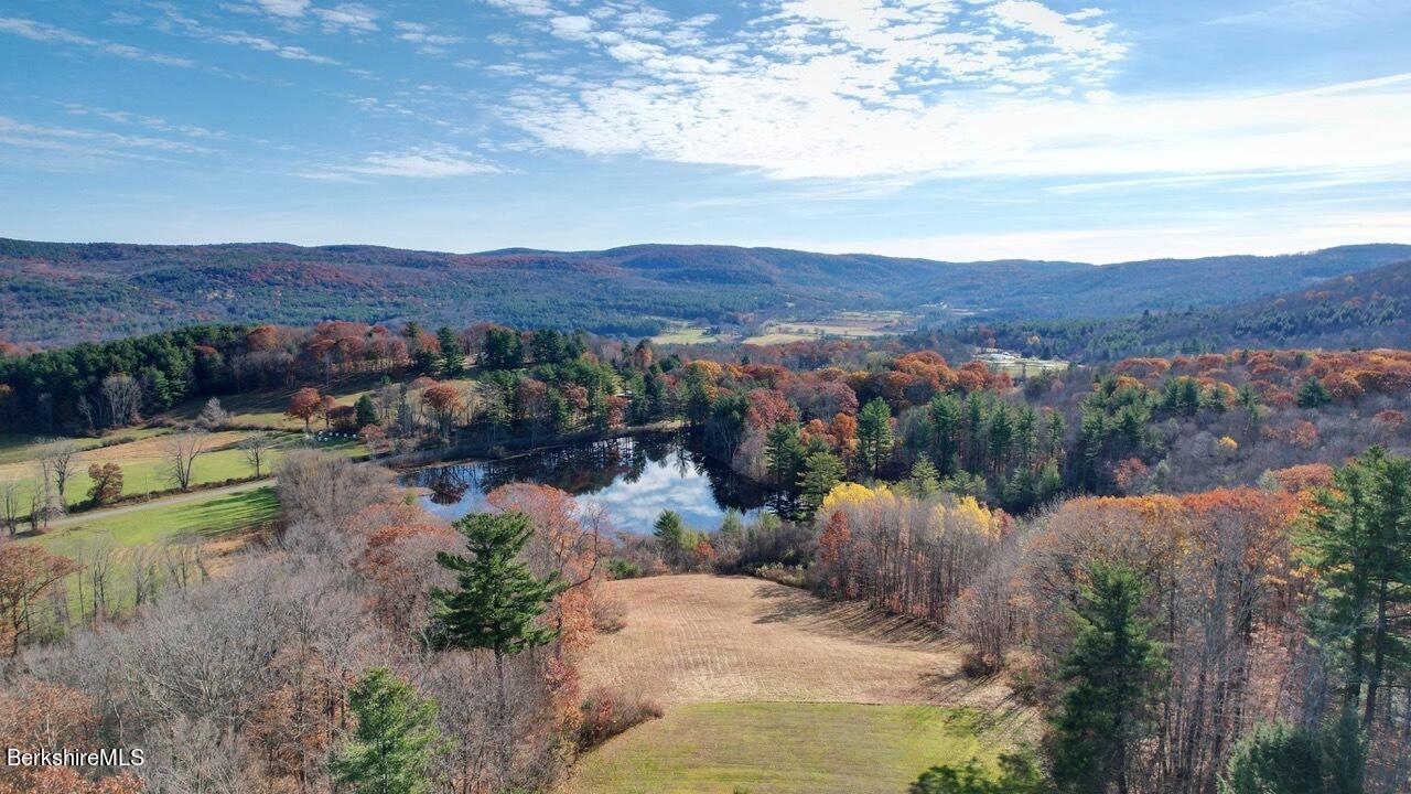 9 Brace Road Tyringham, MA 01264 - Photo 4 of 27 a view of a lake with a mountain in the background