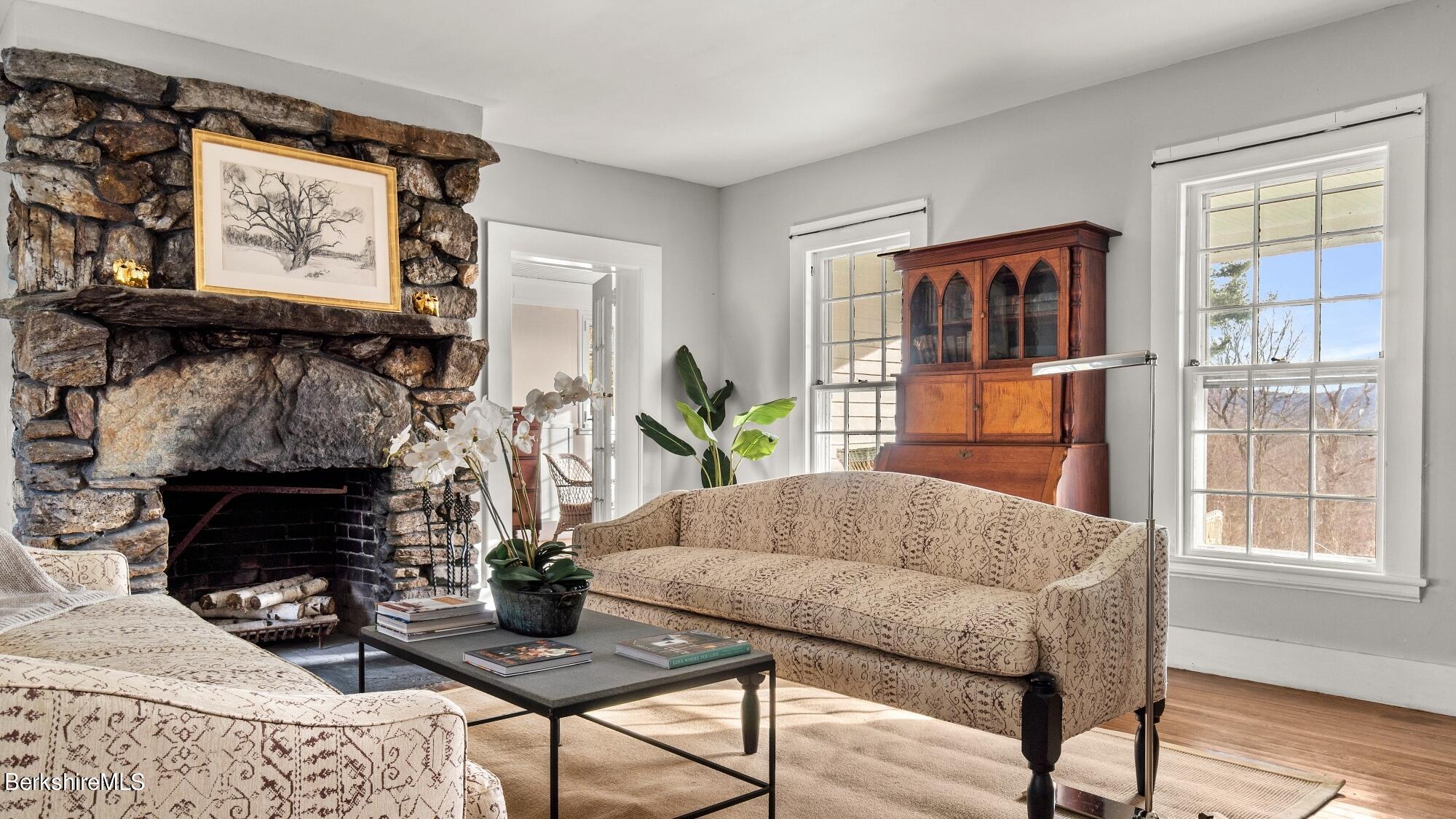 9 Brace Road Tyringham, MA 01264 - Photo 8 of 27 a living room with furniture a large window and a fireplace