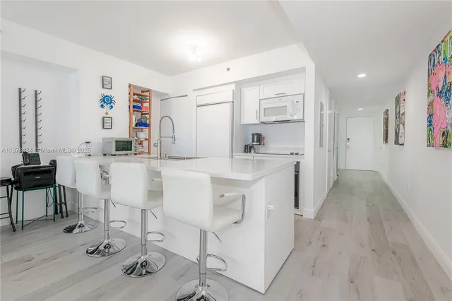 a kitchen with stainless steel appliances kitchen island granite countertop a sink and cabinets