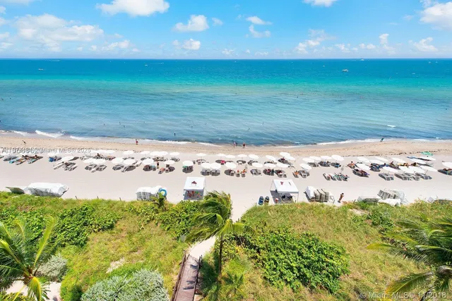 a view of yard with swimming pool and green space
