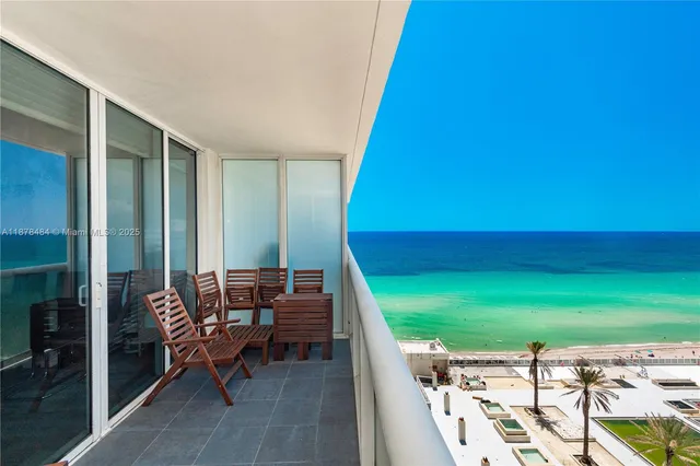 a balcony with chairs and a table