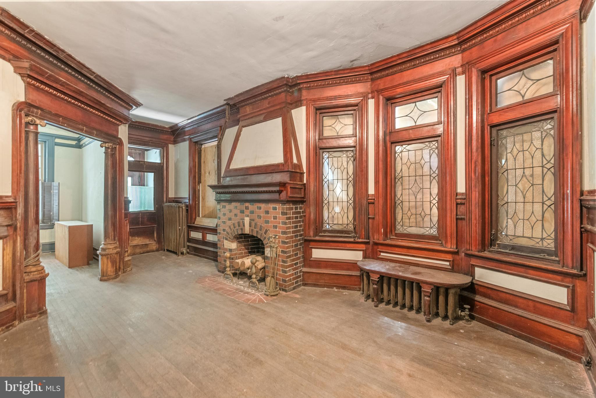 a view of hall way with furniture and a fireplace