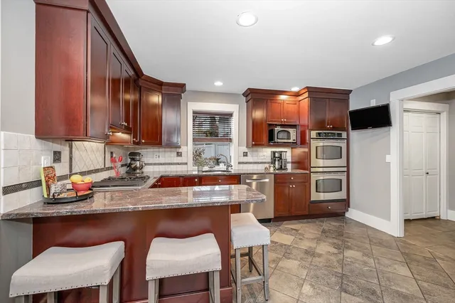 a kitchen with cabinets and chairs