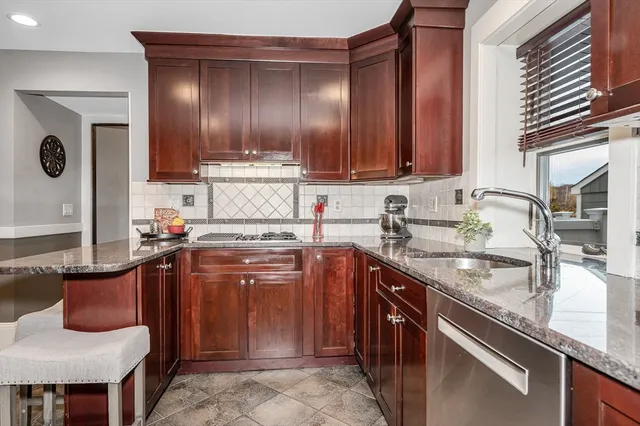 a kitchen with stainless steel appliances granite countertop a refrigerator and a sink