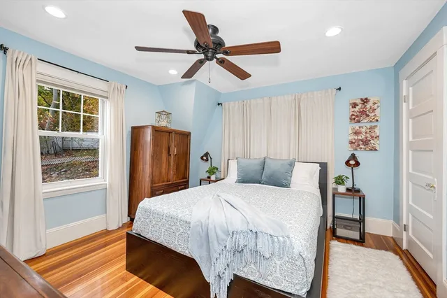 a bedroom with a large bed and a chandelier