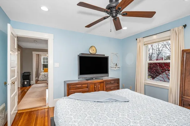 a bedroom with a bed a couch and a window