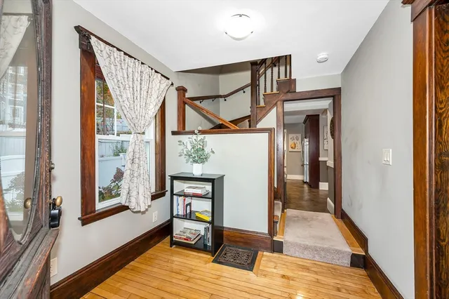 a view of an entryway with wooden floor and door