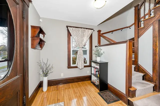 a view of an entryway with wooden floor and a window