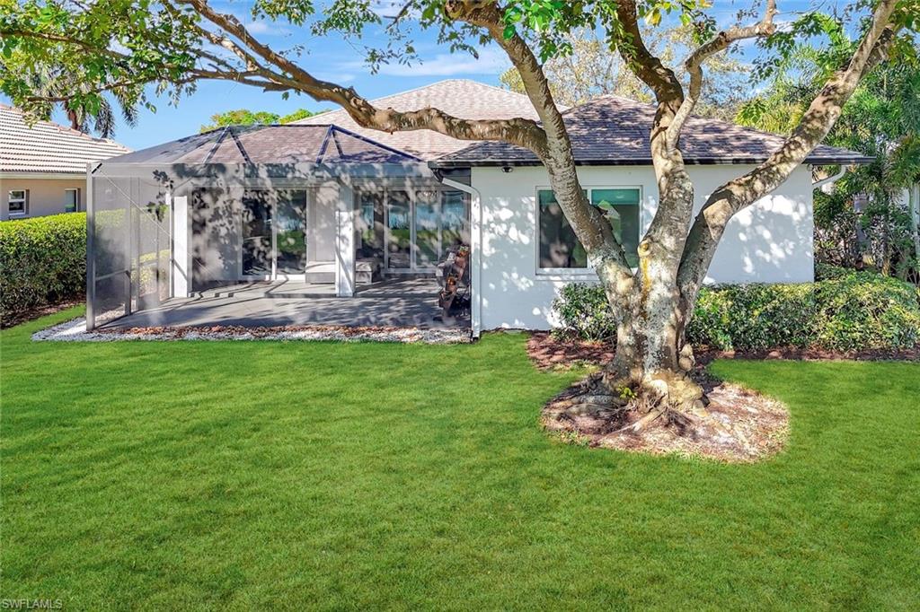 6900 Lone Oak Boulevard Naples, FL 34109 - Photo 16 of 23 a view of a house with a backyard