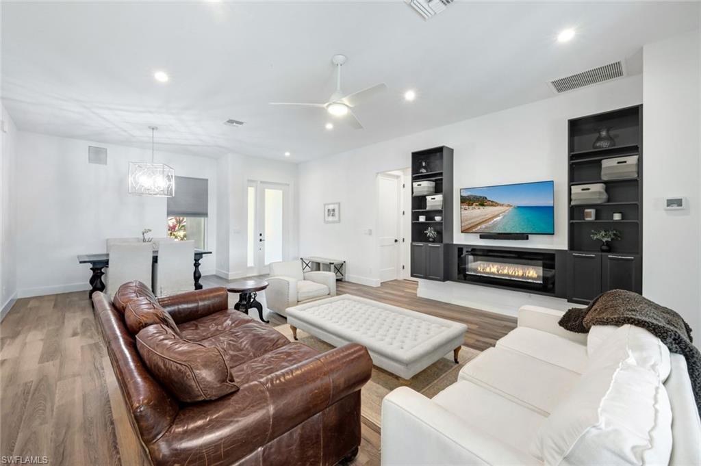 6900 Lone Oak Boulevard Naples, FL 34109 - Photo 2 of 23 a living room with furniture and a flat screen tv