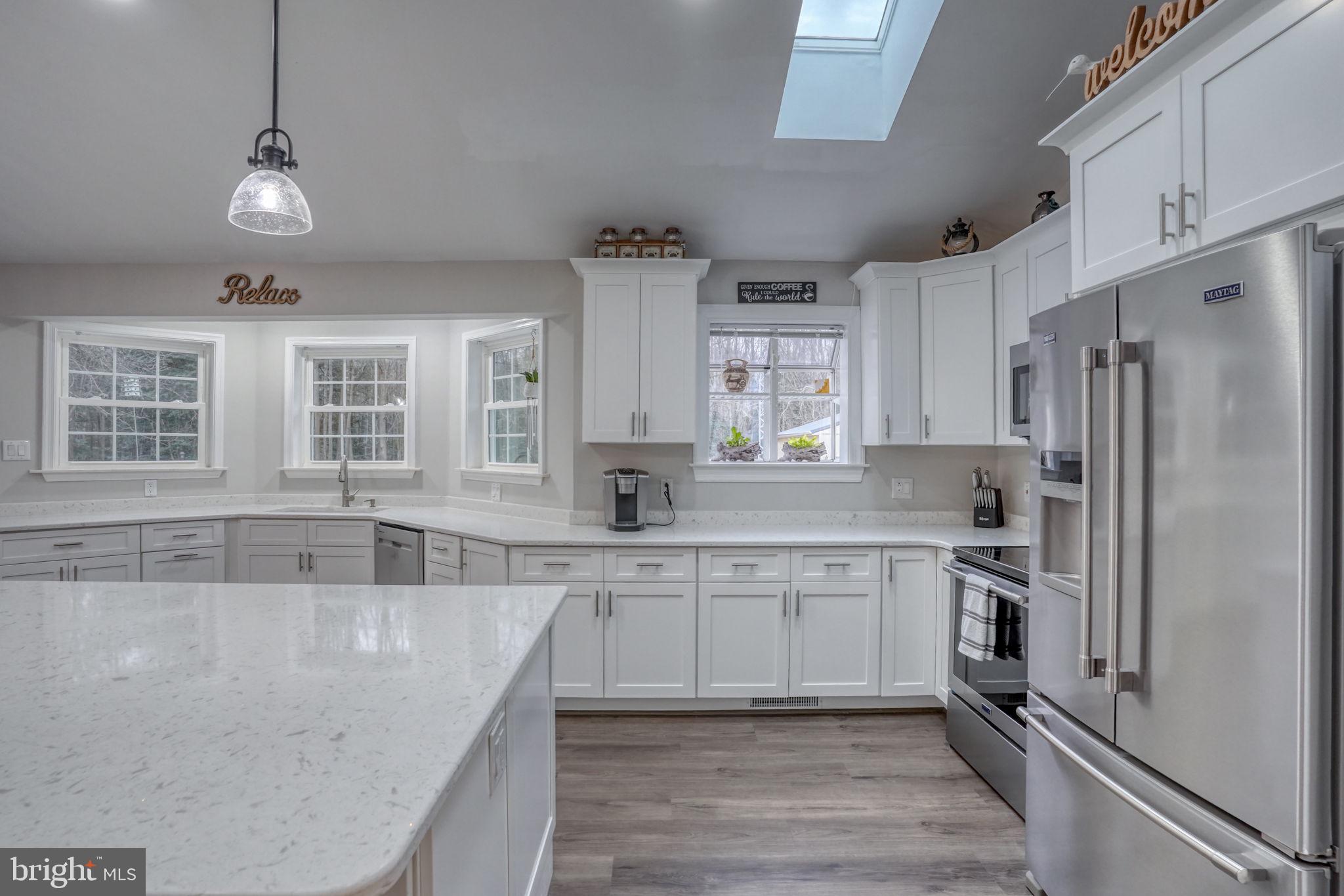 10821 Shawnee Road Harrington, DE 19952 - Photo 21 of 53 a large kitchen with cabinets a sink and stainless steel appliances