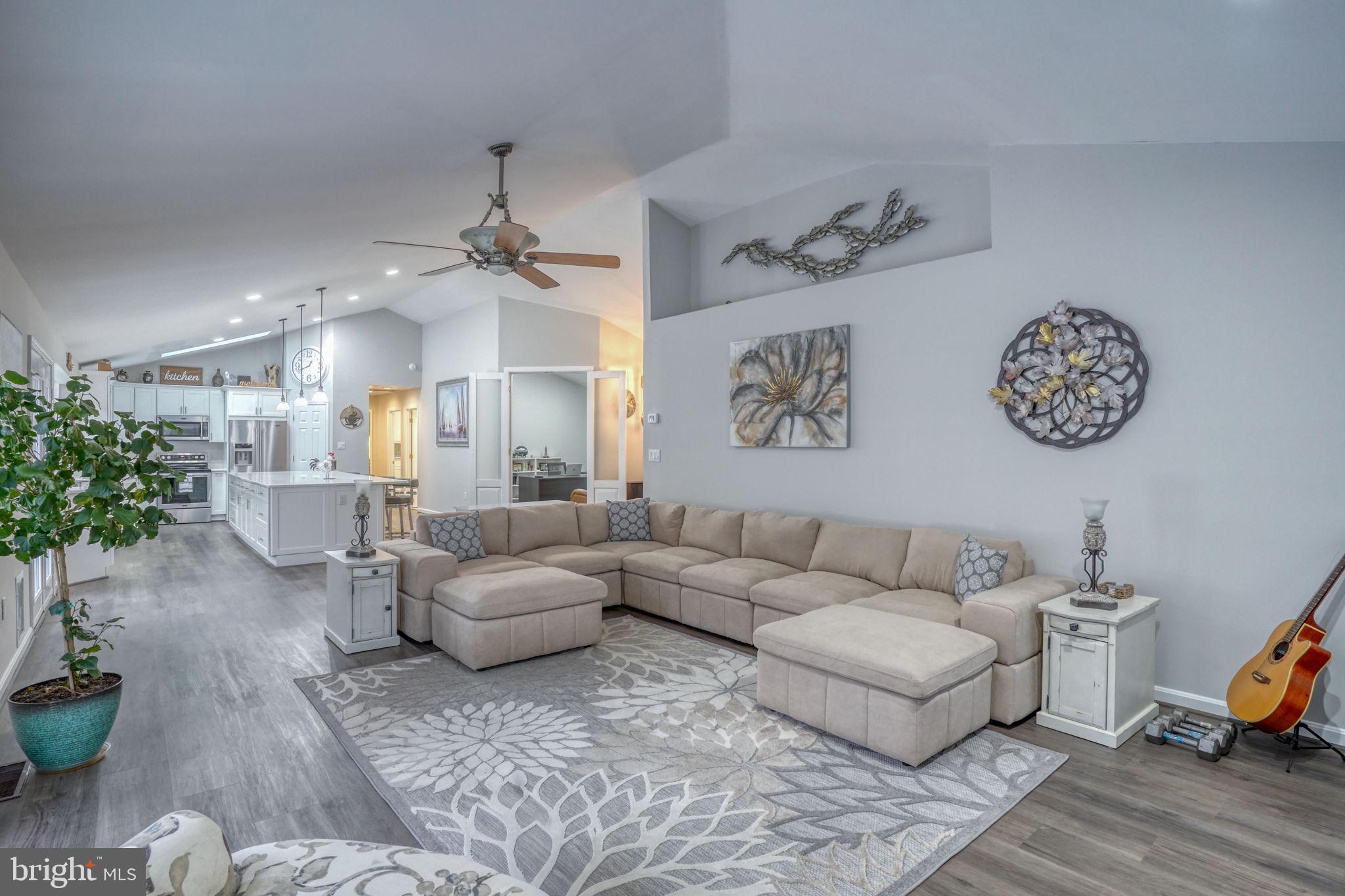 10821 Shawnee Road Harrington, DE 19952 - Photo 26 of 53 a living room with furniture and a chandelier