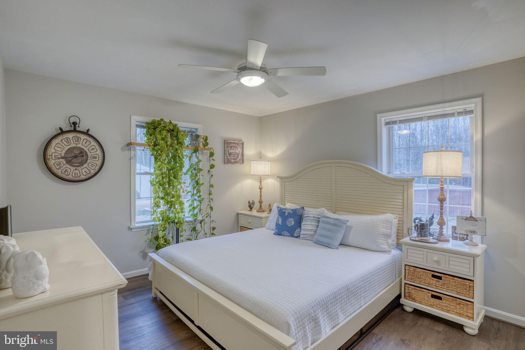 10821 Shawnee Road Harrington, DE 19952 - Photo 38 of 53 a bedroom with a bed and a chandelier