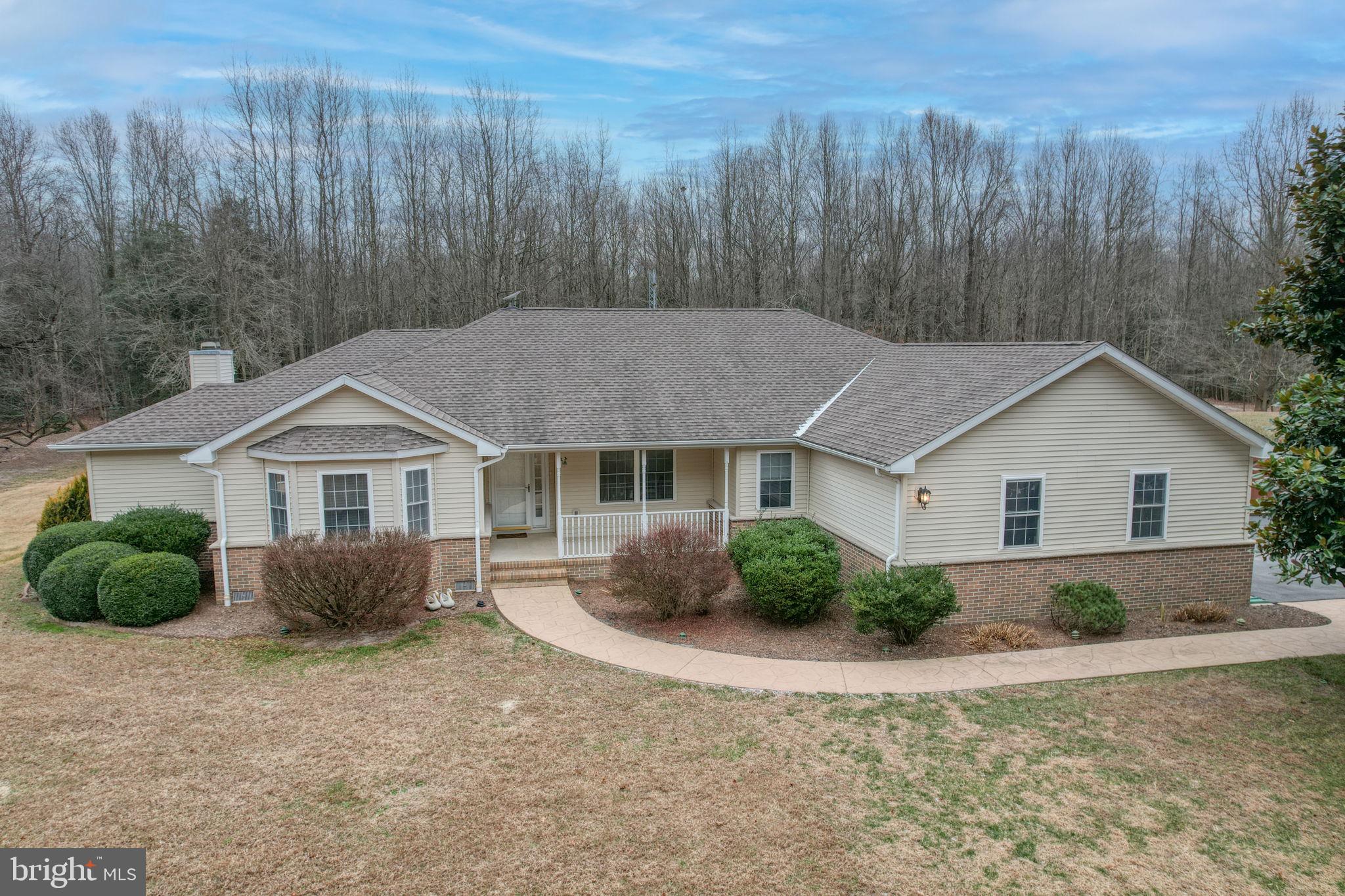 10821 Shawnee Road Harrington, DE 19952 - Photo 4 of 53 a house with trees in the background