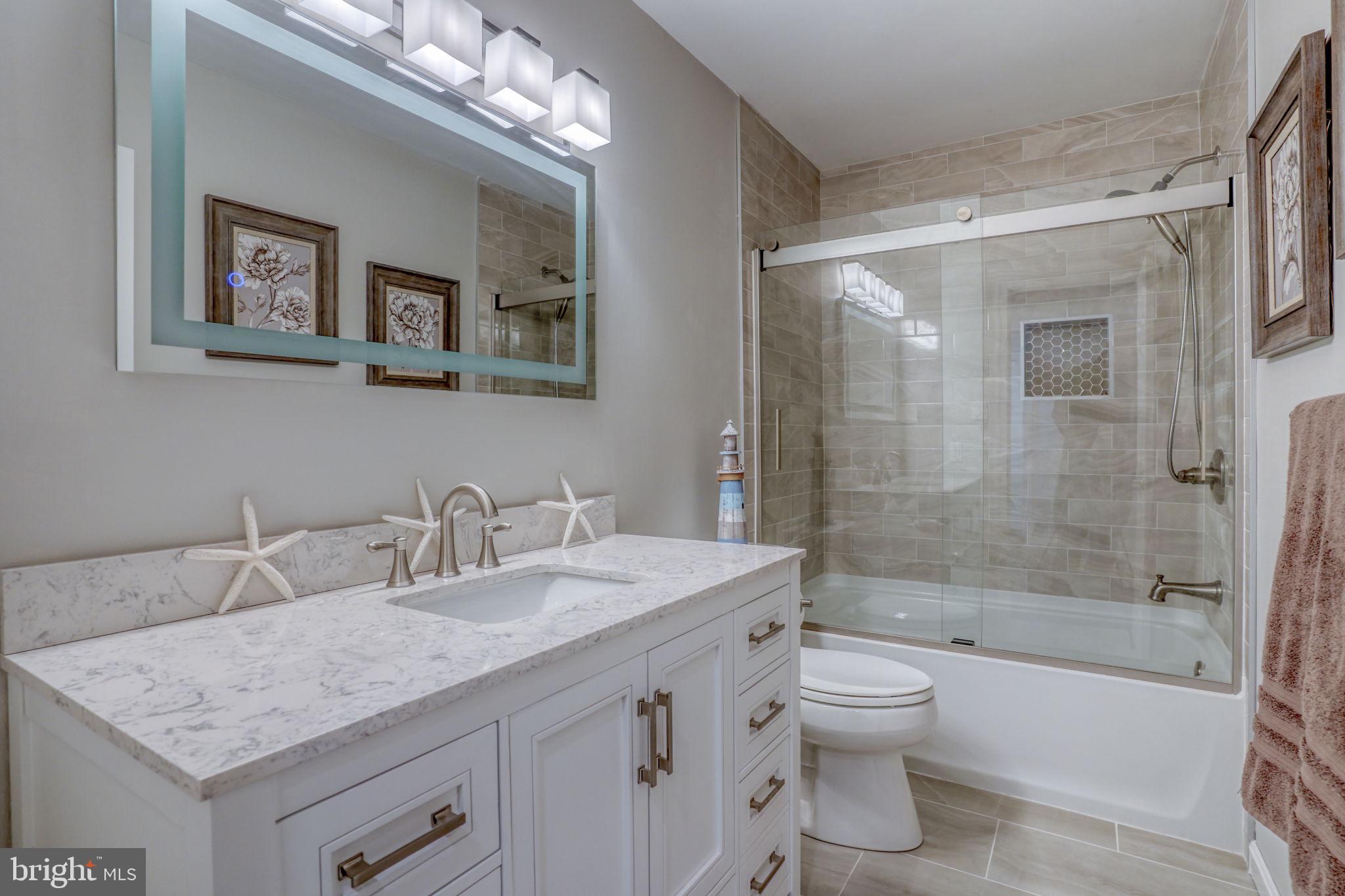 10821 Shawnee Road Harrington, DE 19952 - Photo 41 of 53 a bathroom with a granite countertop sink toilet and shower