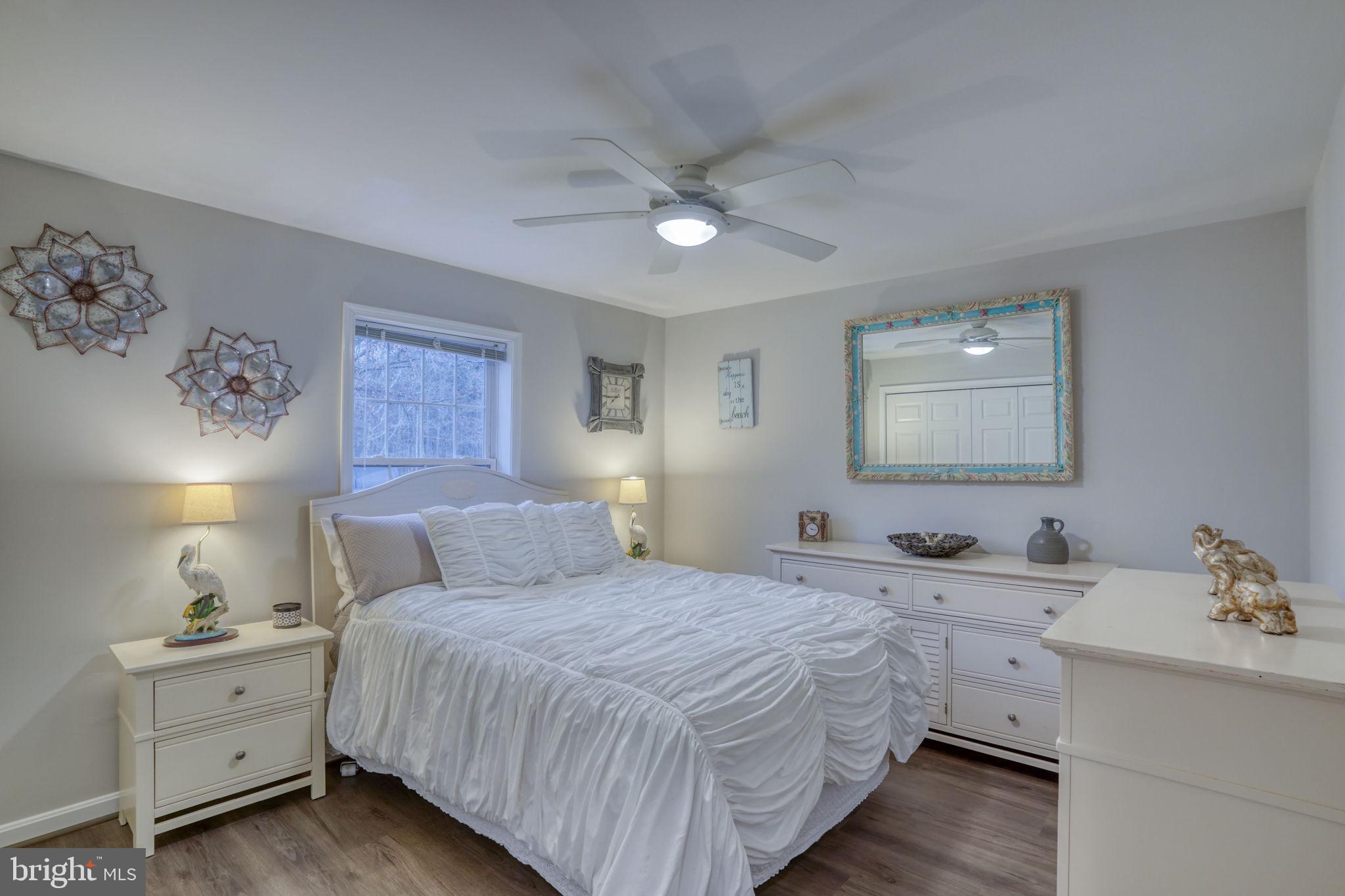 10821 Shawnee Road Harrington, DE 19952 - Photo 43 of 53 a bedroom with a bed and a lamp on dresser