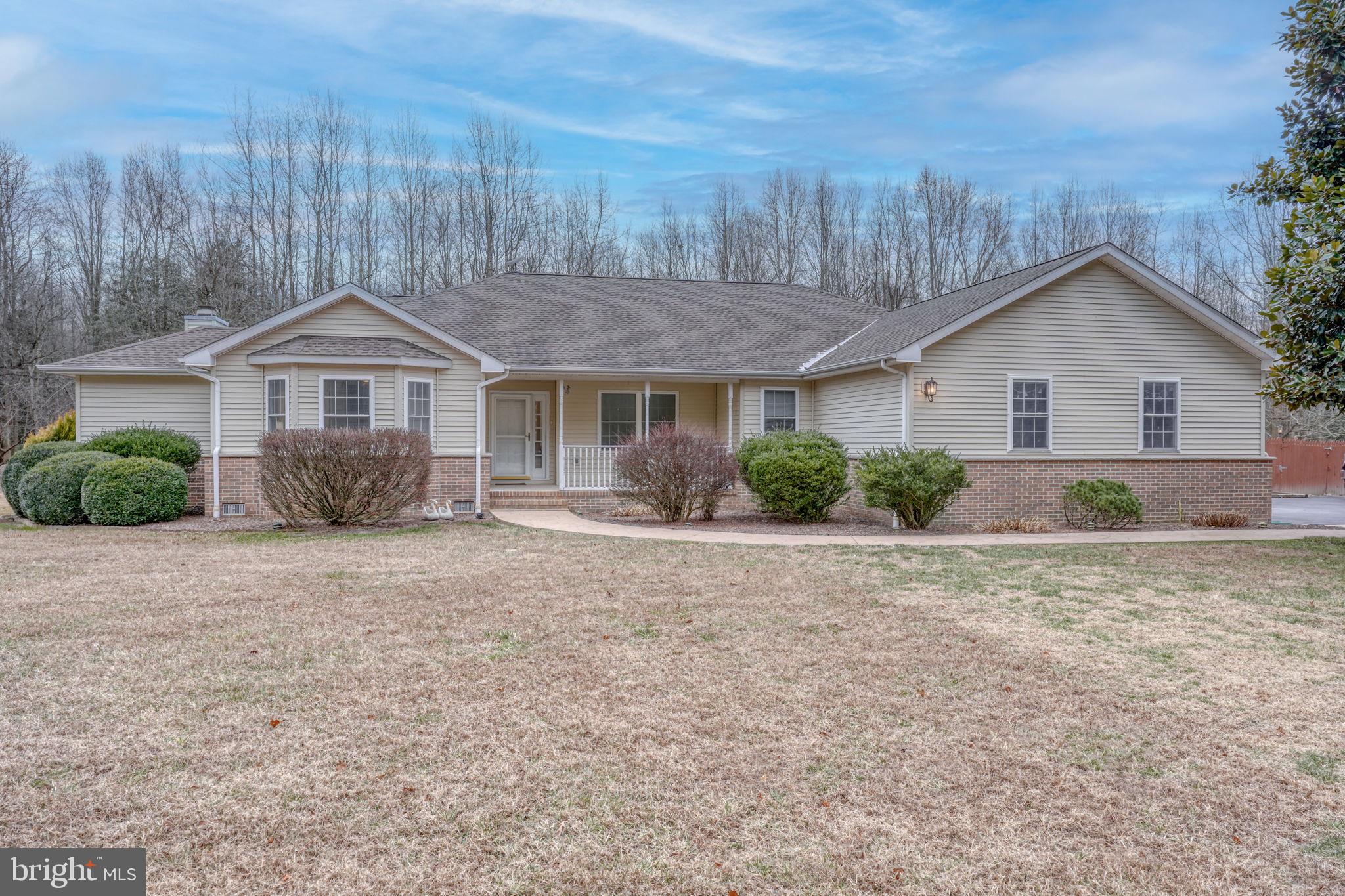 10821 Shawnee Road Harrington, DE 19952 - Photo 53 of 53 a front view of a house with a garden and yard
