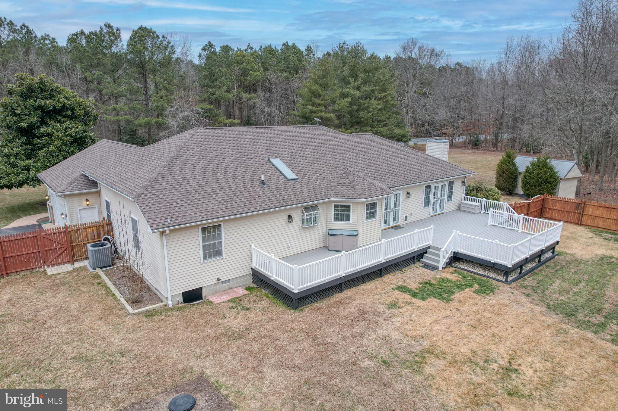 10821 Shawnee Road Harrington, DE 19952 - Photo 8 of 53 an aerial view of a house with a garden and trees