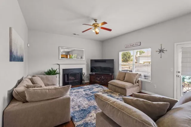 a living room with furniture a fireplace and a flat screen tv