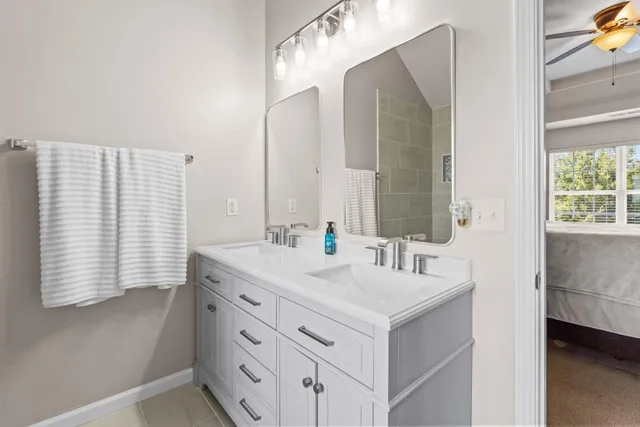 a bathroom with a sink double vanity and a mirror