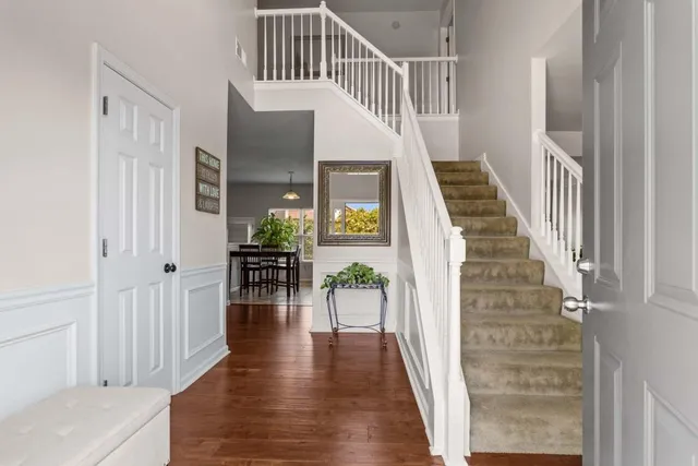 a view of entryway and hall with wooden floor