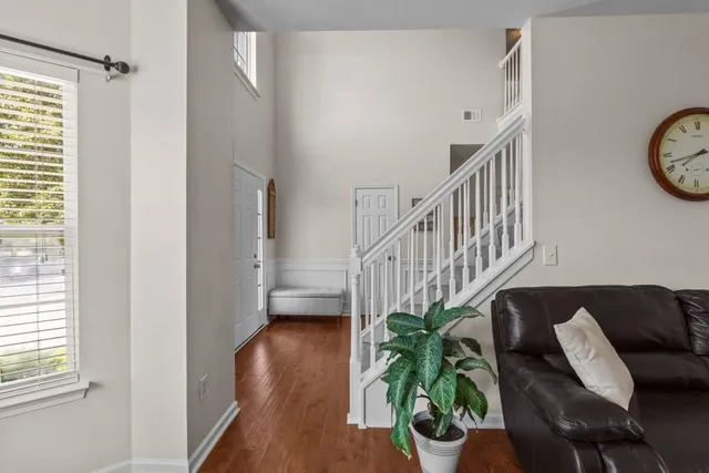 a living room with furniture and a potted plant