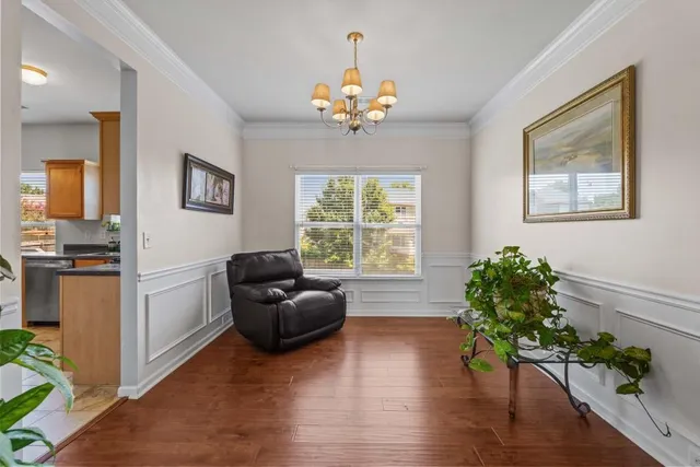 a living room with furniture and a chandelier