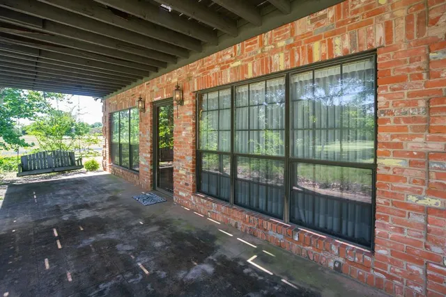 a view of an empty room with a fireplace and a window