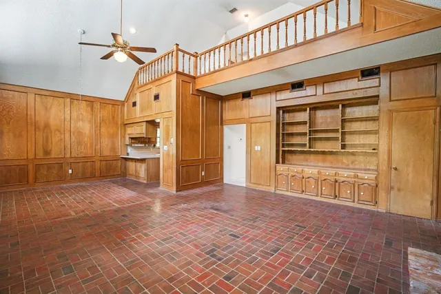 a view of an empty room with a fireplace and a window