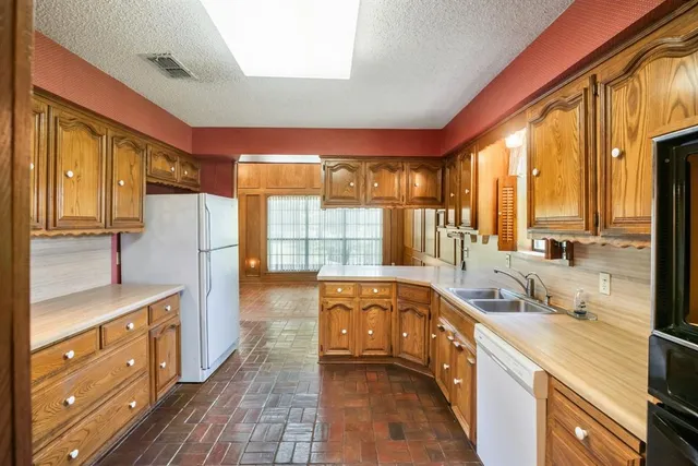 a kitchen with stainless steel appliances granite countertop a sink and a cabinets