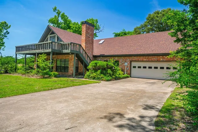 a view of a house with a yard and potted plants