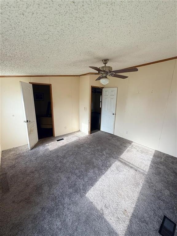 198 East 4th Street Crawford, TX 76638 - Photo 10 of 24 a view of a big room with closet and chandelier fan