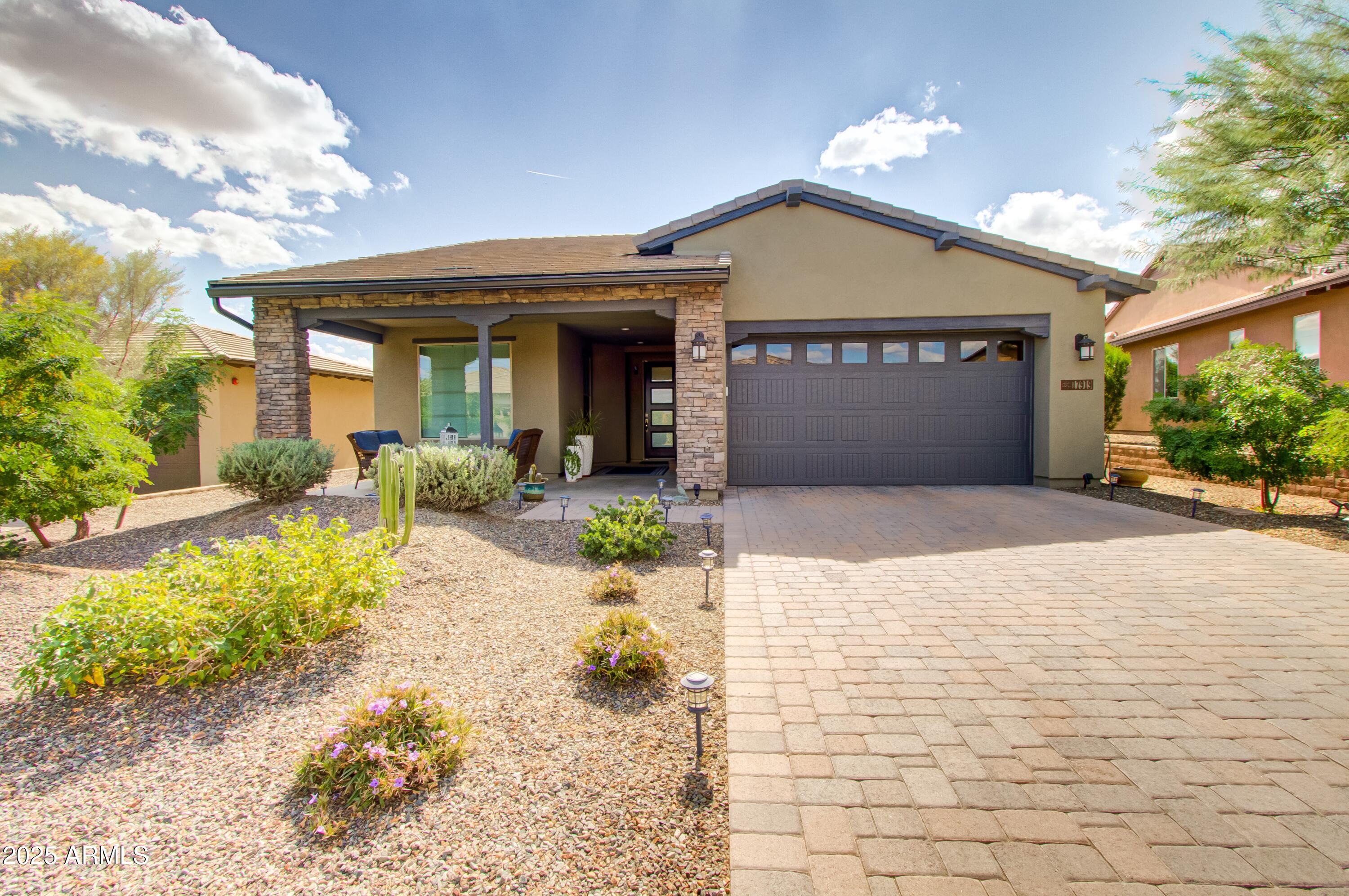 17919 East Slide Rock Drive Rio Verde, AZ 85263 - Photo 2 of 48 a front view of a house with a yard and potted plants
