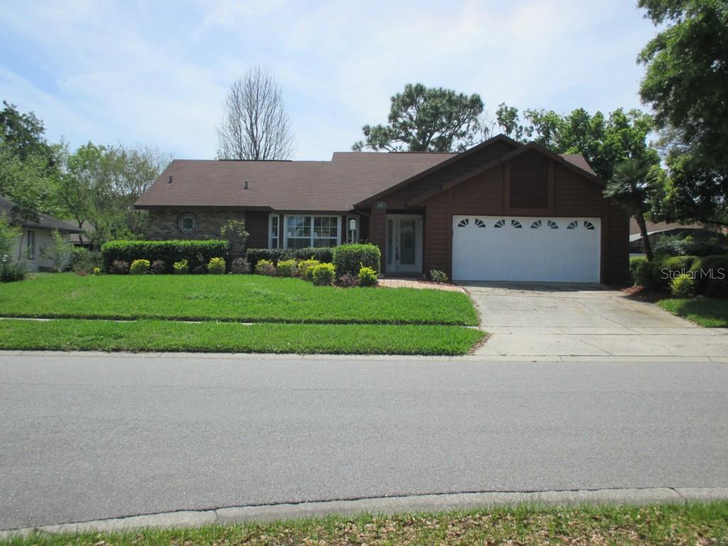 3449 Rider Place Orlando, FL 32817 - Photo 1 of 1 Front of the home showing the Extra Large Lot and Insulated Garage Door. Exceptional Mature Landscaping and Professionally Laid Out Irrigation System.