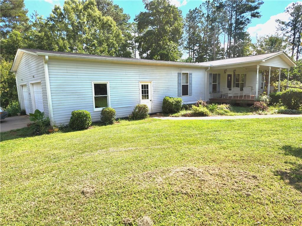 2507 Thaxton Road Franklin, GA 30217 - Photo 1 of 1 a backyard of a house with yard and outdoor seating