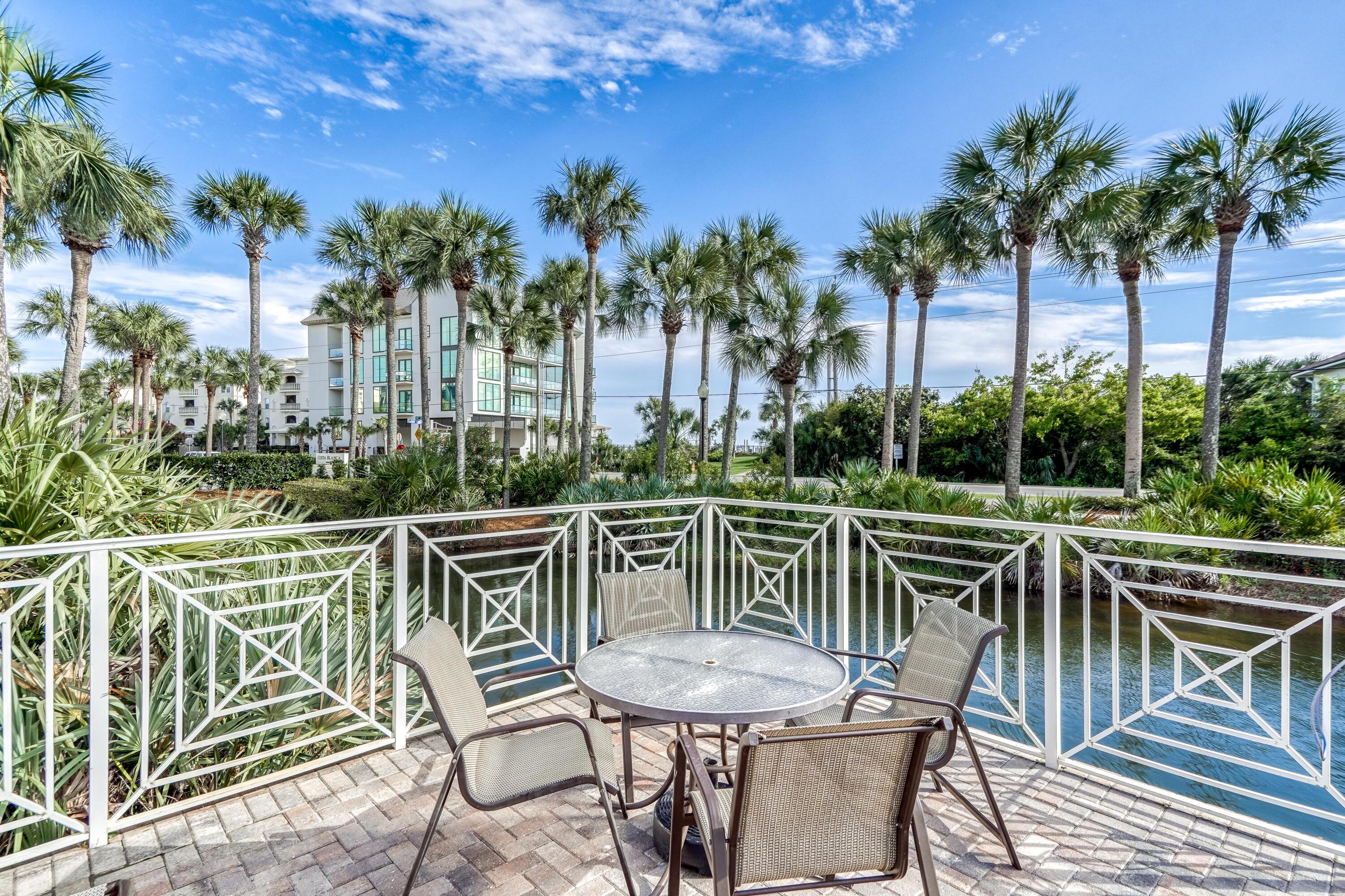 145 Spires Lane, Unit 406 Santa Rosa Beach, FL 32459 - Photo 26 of 38 a view of a chairs and table on the terrace