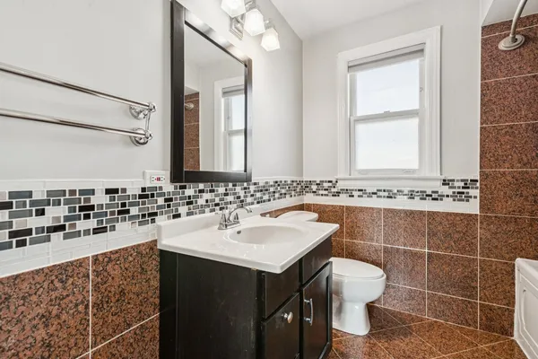 a bathroom with a sink vanity and a mirror