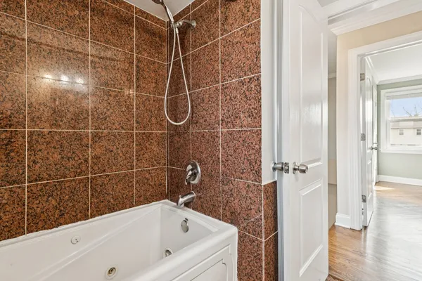 a bathroom with a bathtub and a shower