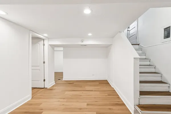 a view of an entryway with wooden floor