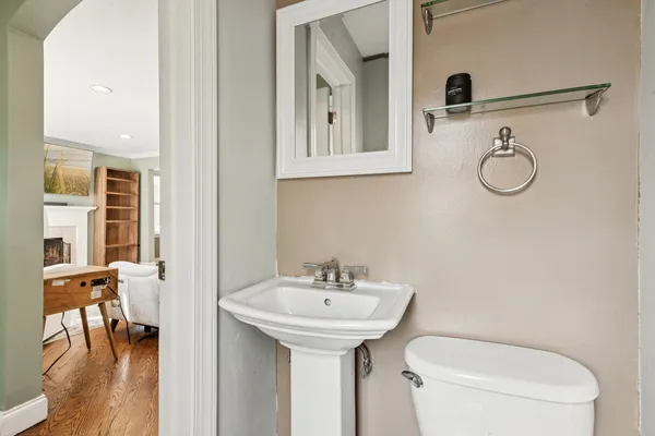 a bathroom with a toilet sink and mirror