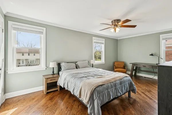 a bedroom with a bed a table and chair