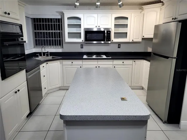 a kitchen with stainless steel appliances a refrigerator and a stove