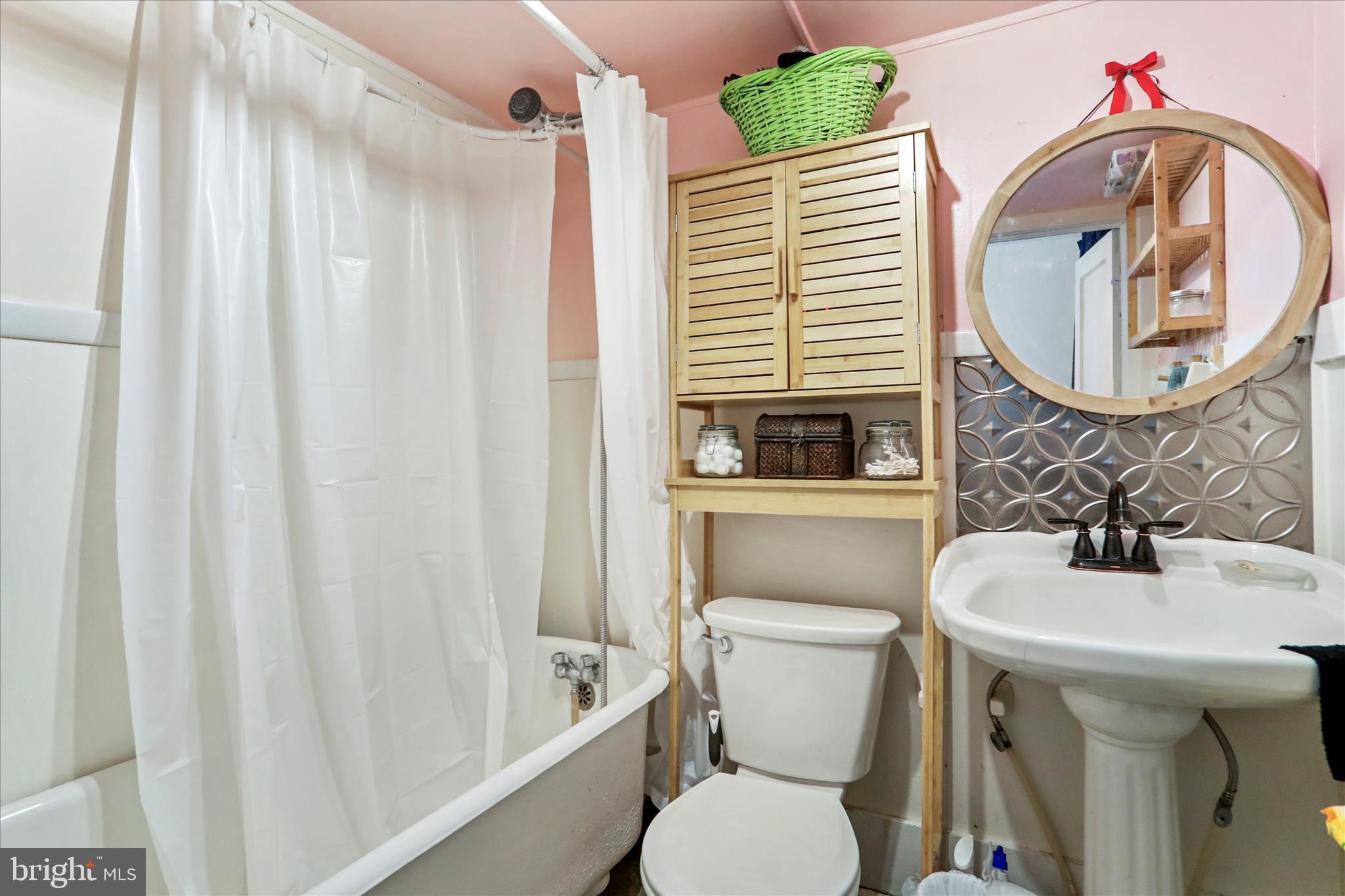 287 East Main Street Romney, WV 26757 - Photo 27 of 48 a bathroom with a sink a mirror a toilet and a window