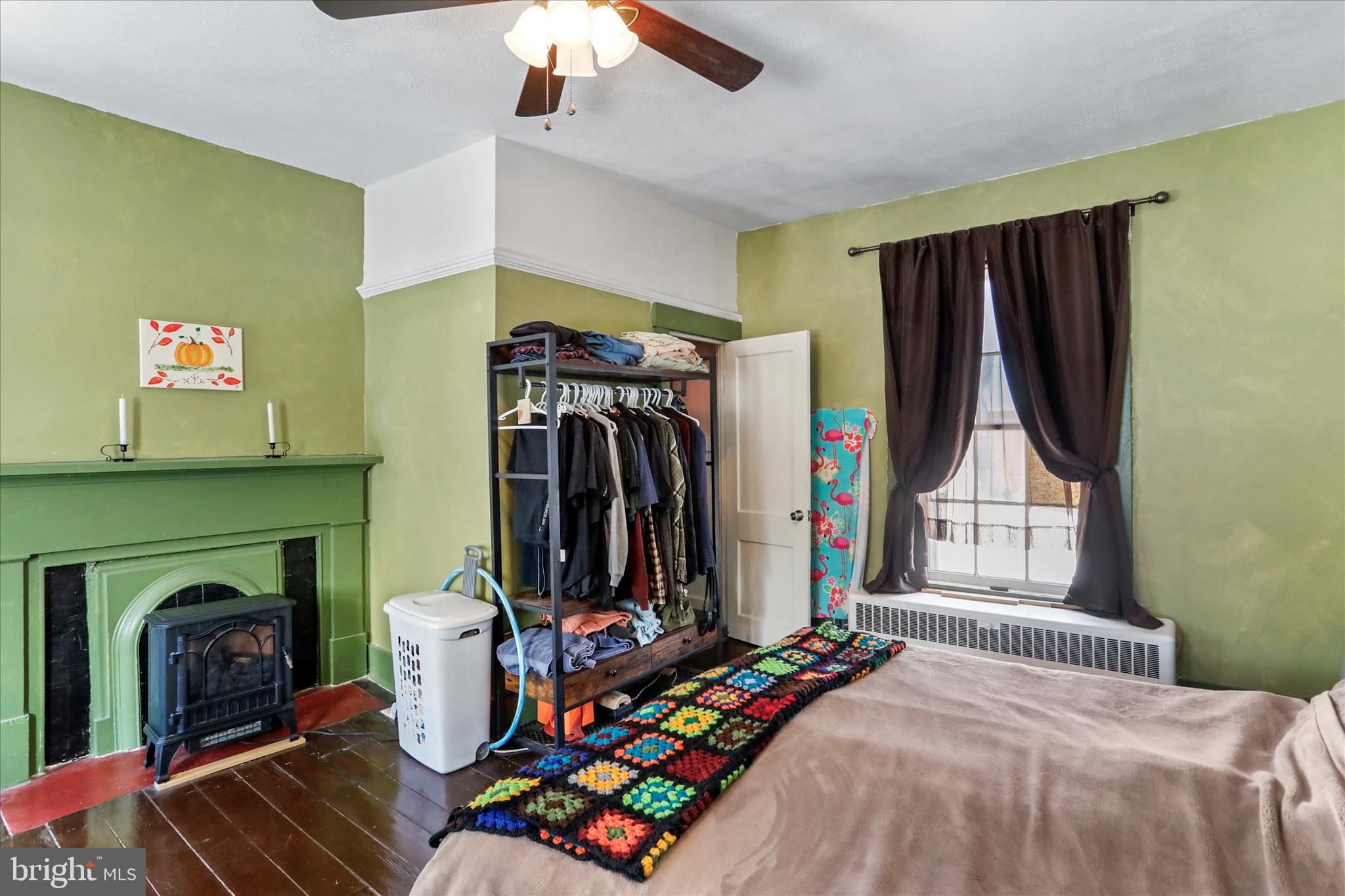 287 East Main Street Romney, WV 26757 - Photo 28 of 48 a bedroom with a bed a fireplace and a window