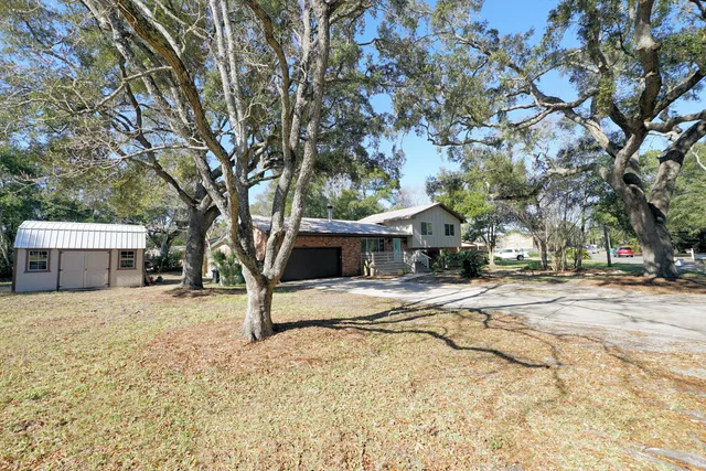 a view of a house with snow on the tree