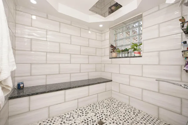 a bathroom with a bathtub and shower