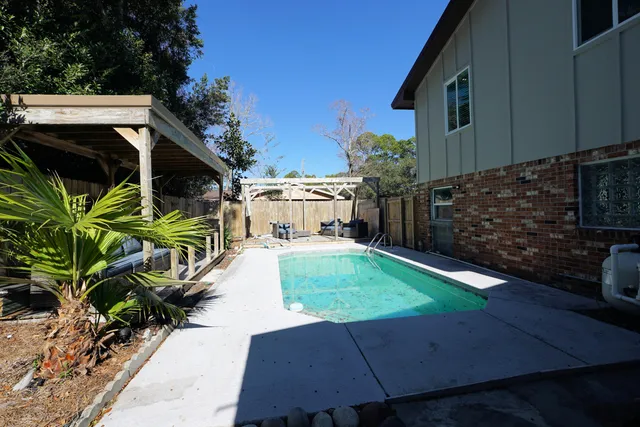 a view of a backyard with sitting area